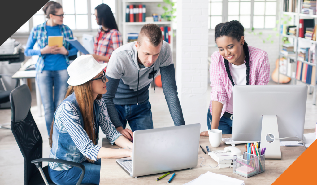 3 employees at a desk brainstorming to unleash the power of creative thinking