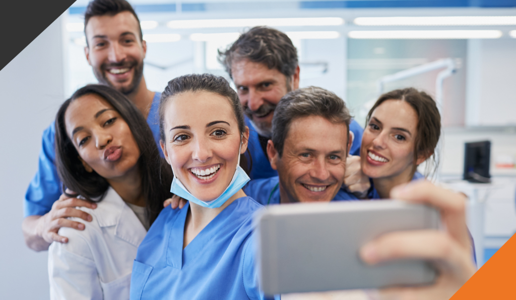 six healthcare workers gathered to take a selfie demonstrating stress management strategies for healthcare workers